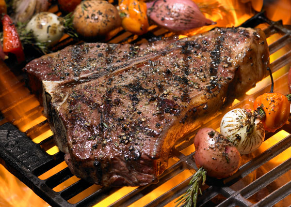 Grilling Steak on open flame