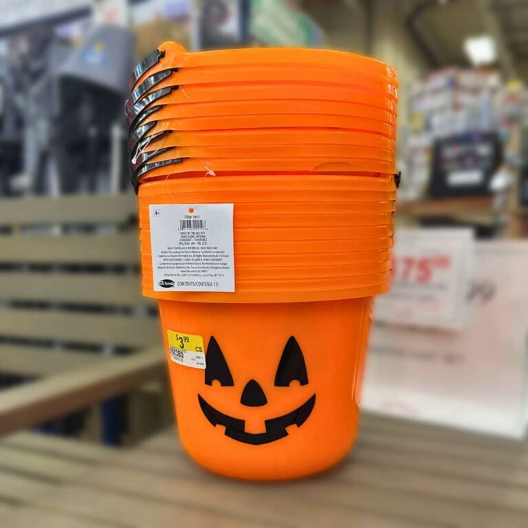 Classic orange jack-o-lantern plastic trick or treat buckets stacked at Johnsons Home and Garden