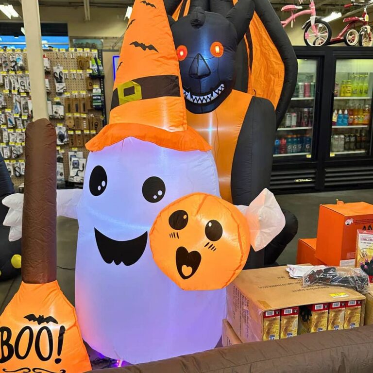 Cute inflatable ghost holding pumpkin with witch hat Halloween lawn sign at Johnsons Home and Garden